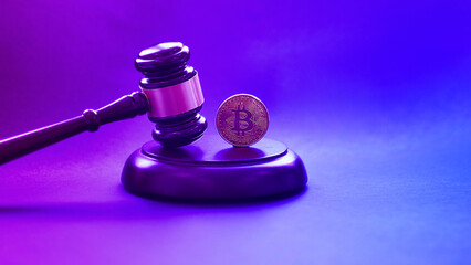 Crypto currency law theme, gavel and bitcoin symbol on black table with copyspace.