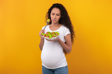 Portrait of Sad Pregnant Lady Holding Plate With Vegetable Salad