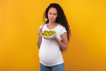 Portrait of Sad Pregnant Lady Holding Plate With Vegetable Salad