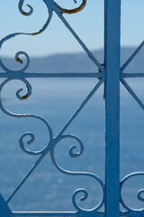 Part of a traditional metallic door and view of the aegean sea in Santorini