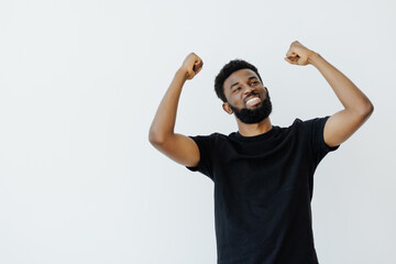 Naklejka premium Young African man isolated on white background raising fist after a victory, winner concept.