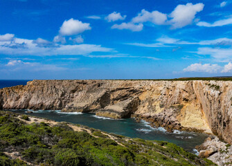 Natural view of the coast of Algarve in Portugal under a blue sky