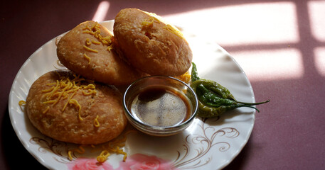 Kachori and samosa, Indian vegetarian snacks served with green and tamarind chutneys.