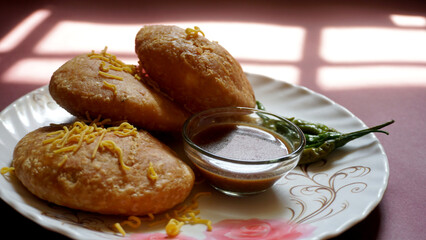 Kachori and samosa, Indian vegetarian snacks served with green and tamarind chutneys.