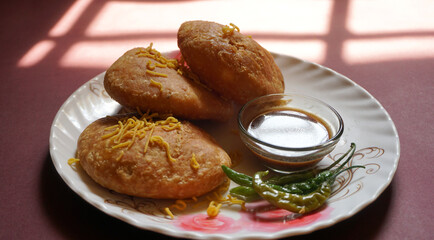 Kachori and samosa, Indian vegetarian snacks served with green and tamarind chutneys.