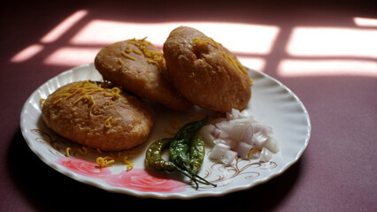 Kachori and samosa, Indian vegetarian snacks served with green and tamarind chutneys.