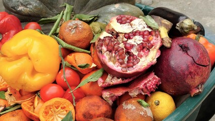 Unsold damaged uneaten fruits and vegetables in the landfil. Food waste and loss