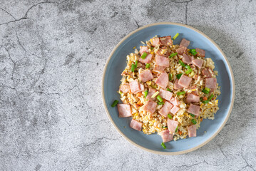 Top view of fried rice with ham as lunch on table, simply menu