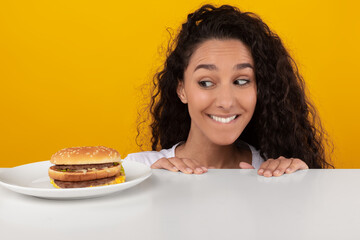 Hungry Lady Looking At Burger Peeping Out Table