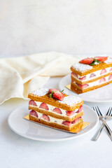 Strawberry cake slice on a white background. Layered cake with cream and strawberry. close up