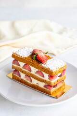 Strawberry cake slice on a white background. Layered cake with cream and strawberry. close up