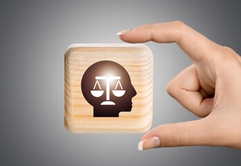 The wooden cubes with a head symbols  background. Business weight concept.