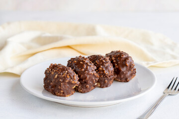 Chocolate petit four cake on a white background. close up