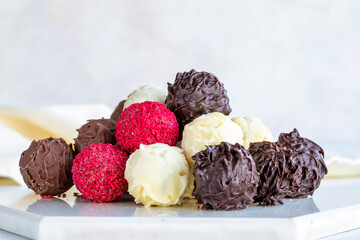 Truffle chocolate assortment on a white background. homemade chocolate pralines. close up