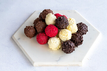 Truffle chocolate assortment on a white background. homemade chocolate pralines. close up