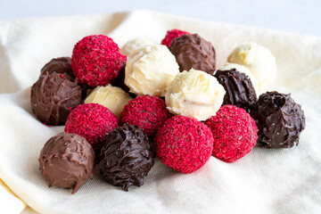 Truffle chocolate assortment on a white background. homemade chocolate pralines. close up