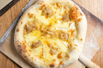 pizza de quesos a la piedra recien salida del horno