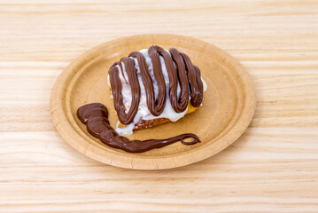 Cinnamon roll with cream sugar and a lot of nutella