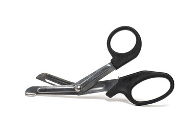 Closeup bandage scissors safe cutting white background