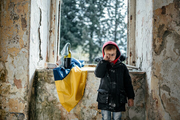 Little Boy in a Ruined House War in Ukraine Ukrainian flag