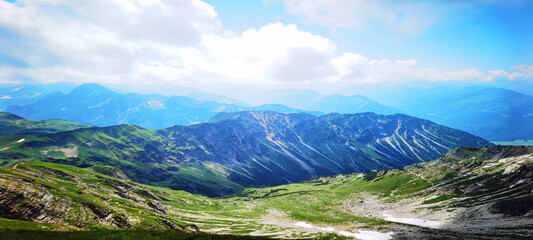 Panoramic view from Nebelhorn in Oberstdorf Allgäu Bavaria Germany - Beautiful Alps with lush green meadow and blue sky - Mountains landscape background banner panorama..