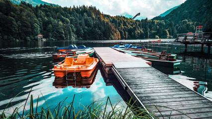 Freibergsee with pedal boats and a view of the ski jump in Oberstdorf