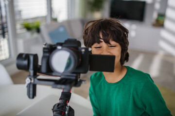Happy multiracial boy cameraman amateur at home. © Halfpoint