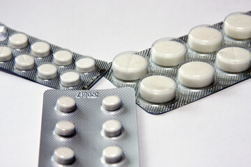 medicinal pills and capsules in blisters close-up. macro shooting of multicolored pills of...
