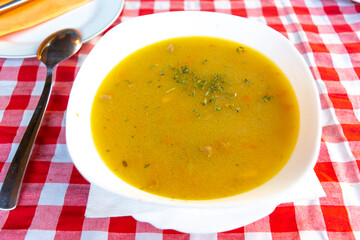 Serbian national dish soup veal corba along with bread in the background.