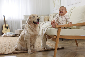 Cute little baby with adorable dog at home
