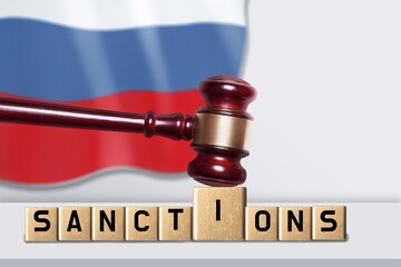Classic judge's gavel with wooden cubes for the text with Russian flag, Concept on the of sanctions...