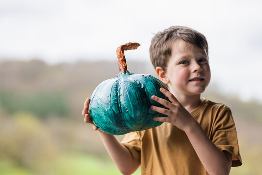 Cute boy with teal pumpkin