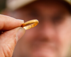 Closeup shot of an old gold ring in the finder's hand