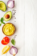 Spicy guacamole avocado dip with herbs and tomatoes