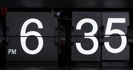 Flip Clock Showing at 6:35 p.m. Spinning on black background.