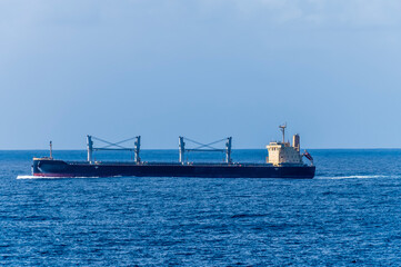 A view of a bulk carrier vessel approaching the straits of Gibraltar on a spring day
