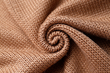 Brown knitted fabric as background, top view