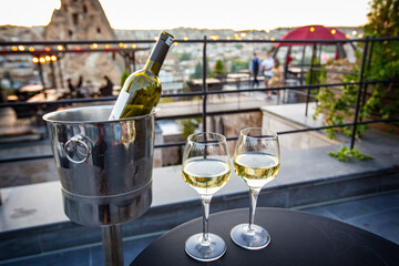 Bottle of wine and two glasses at sunset at Goreme, Cappadocia, Turkey