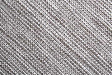 Beautiful grey knitted fabric as background, top view