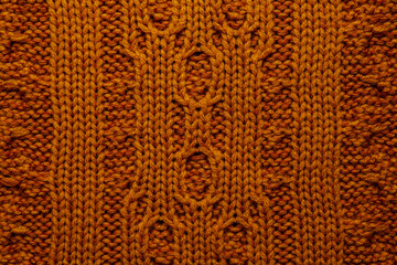 Beautiful orange knitted fabric as background, top view