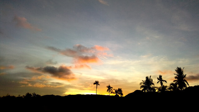 Beautiful shot of a bright sunset sky over a field in Siquijor, Philippines