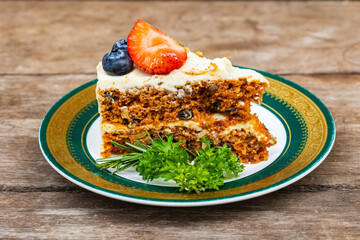 The fruit cake  in the plate on wooden table.
