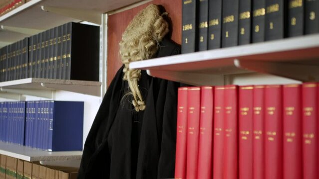 A judge's wig and gown hanging in the chamber of a courtroom law library