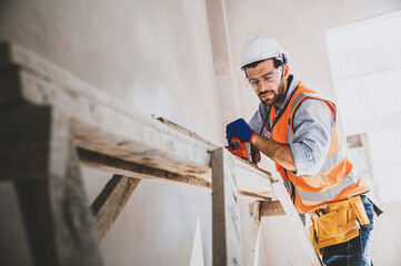 Engineer caucasian man using wood planer in work site