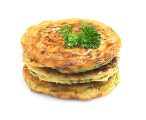 Delicious zucchini fritters with curly parsley on white background