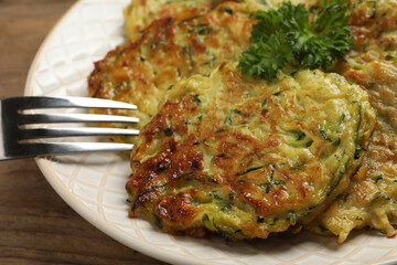 Delicious zucchini fritters served on table, closeup