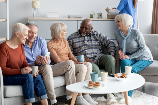 Multiracial group of cheerful elderly people chilling together
