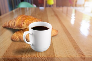 Espresso or black coffee in white cup with croissants