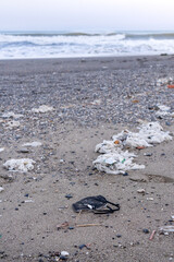 Beach full of garbage, wet wipes and waste that people throw in the toilet. Concept of ocean pollution and environmental destruction, Málaga, Spain.