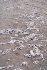 Beach full of garbage, wet wipes and waste that people throw in the toilet. Concept of ocean pollution and environmental destruction